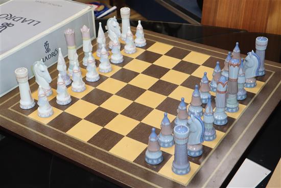 A Lladro chess set, 32 pieces, in medieval style with wooden inlaid board